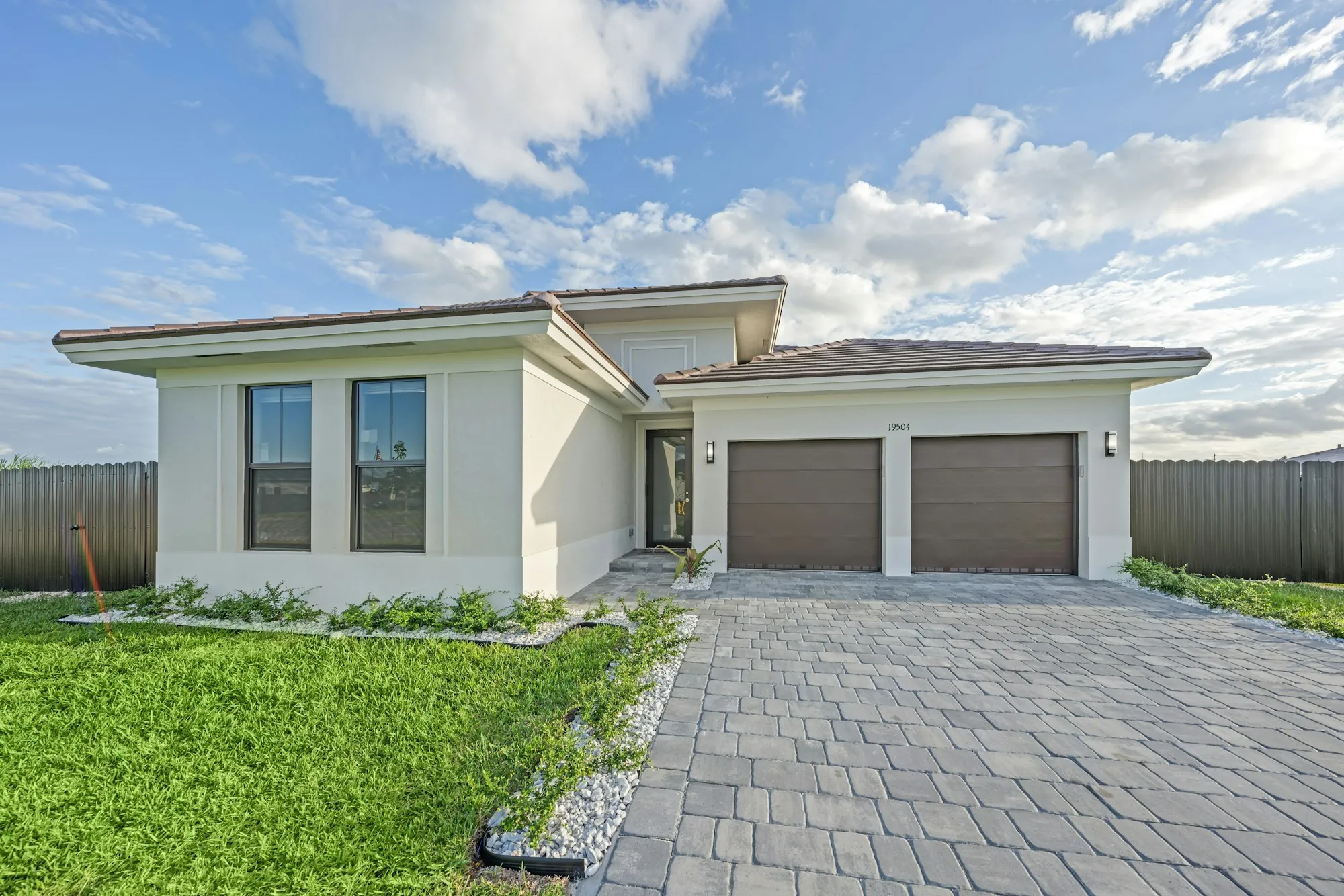 Single-story house with a two-car garage and paver driveway, the kind of Robbins home where planning a roof replacement with solar panels starts
